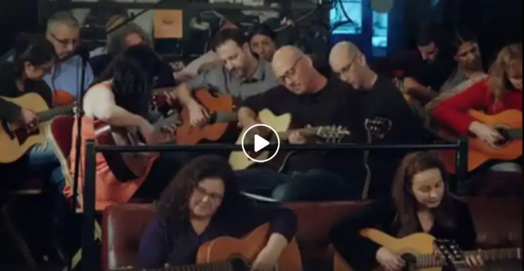 150 beginner guitar students, 100 guitars and a great song by Danny Robas